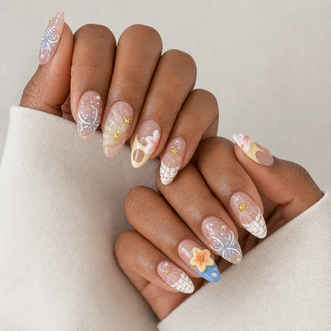 Sunlit Lagoon 3D flower and shell manicure on two medium-brown hands