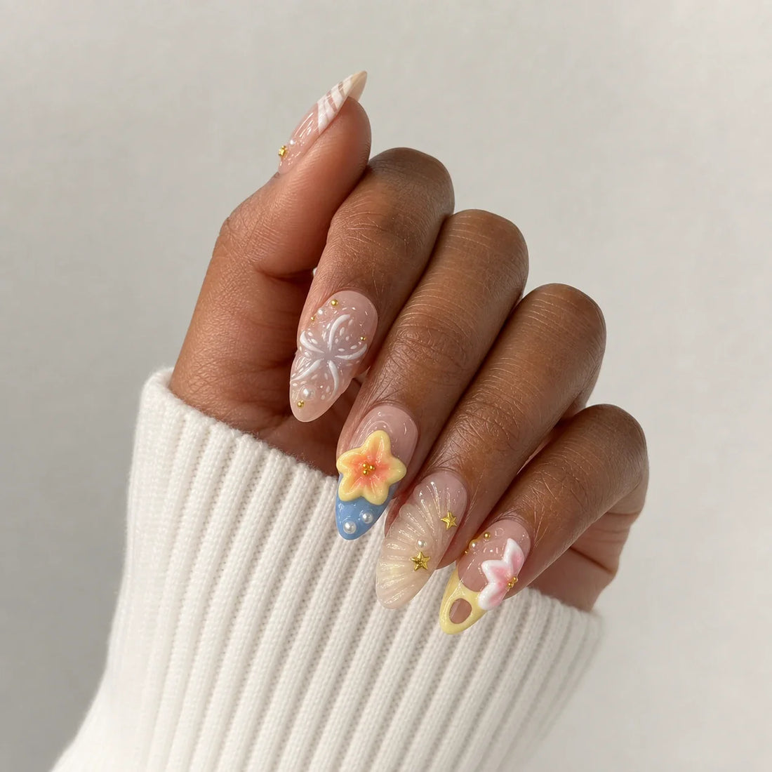 Sunlit Lagoon 3D floral press-on manicure on one medium-brown hand