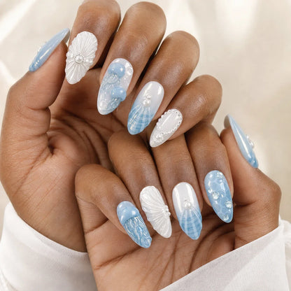 Tidal Cameo pearlescent ocean press-on nails on two medium-brown hands
