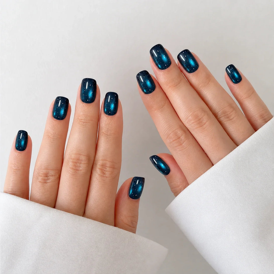 Twin Nebula short square press-on nails on two open hands