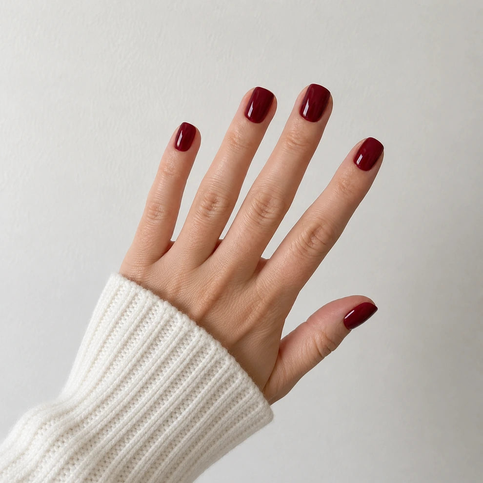 Velvet Merlot short square burgundy press-on nails in a wide open-hand view