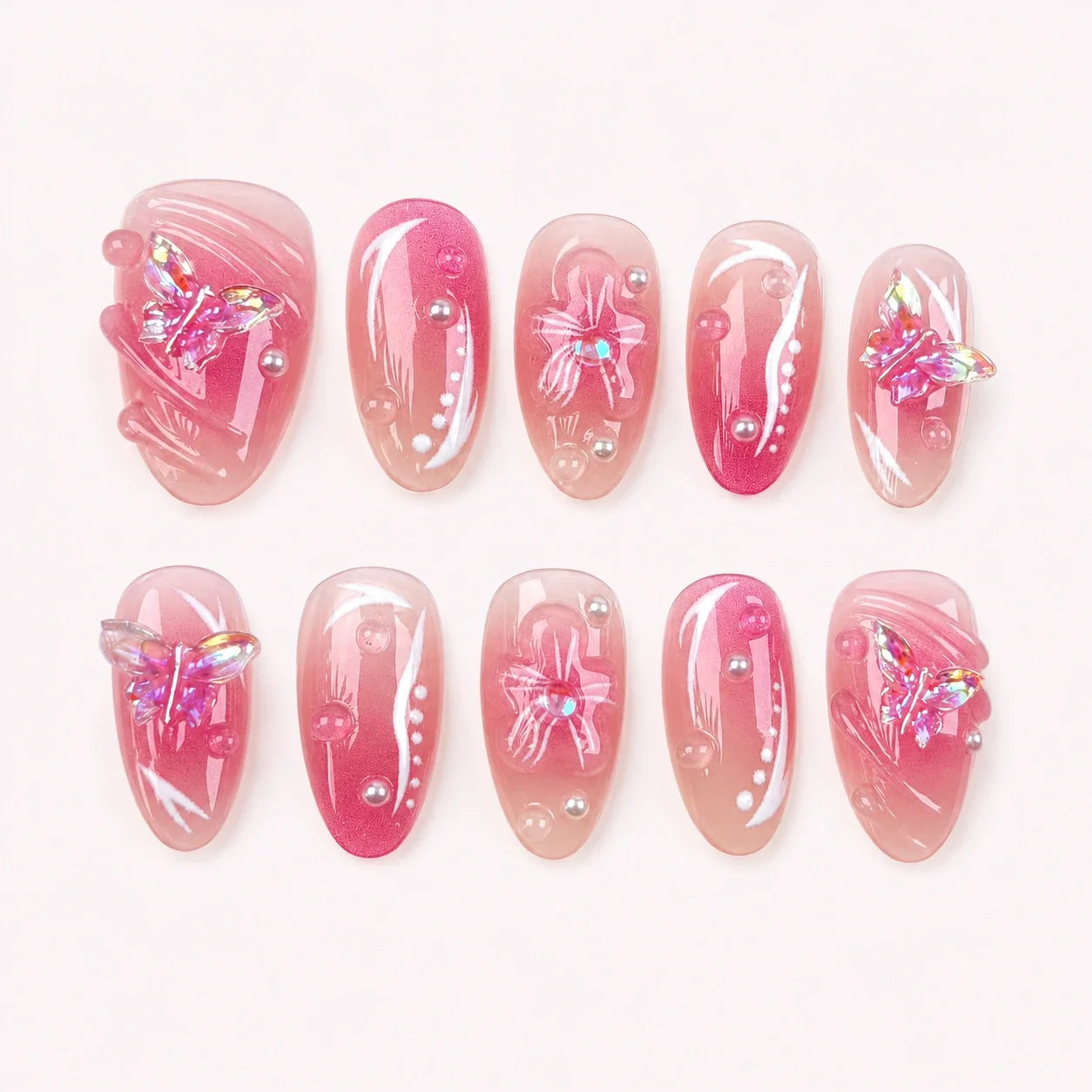 Winglight short almond press-on nails in blush-pink jelly with iridescent butterfly charms