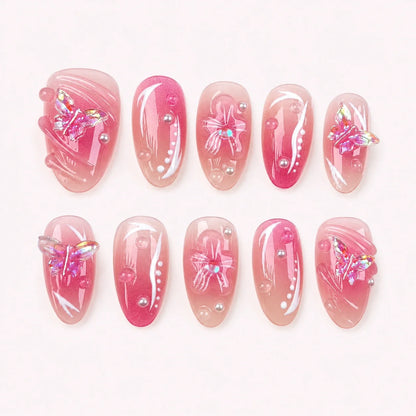 Winglight short almond press-on nails in blush-pink jelly with iridescent butterfly charms