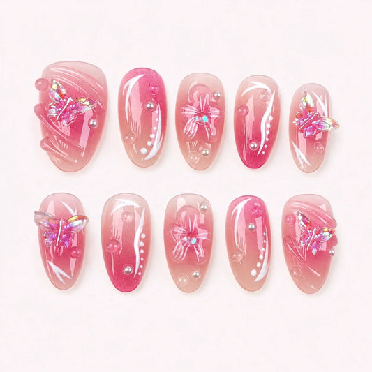 Winglight short almond press-on nails in blush-pink jelly with iridescent butterfly charms