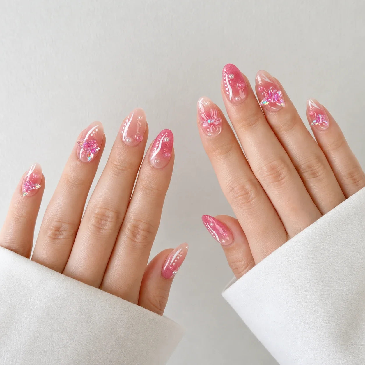 Winglight short almond press-on nails on two open hands