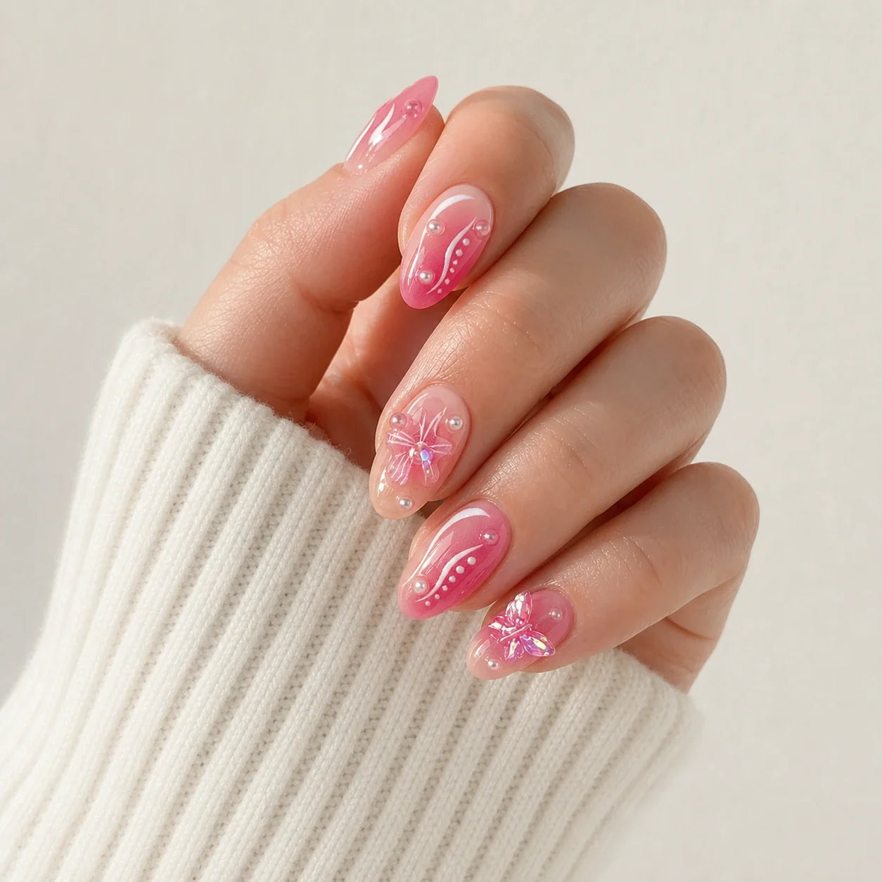 Winglight iridescent butterfly press-on manicure on one softly curled hand