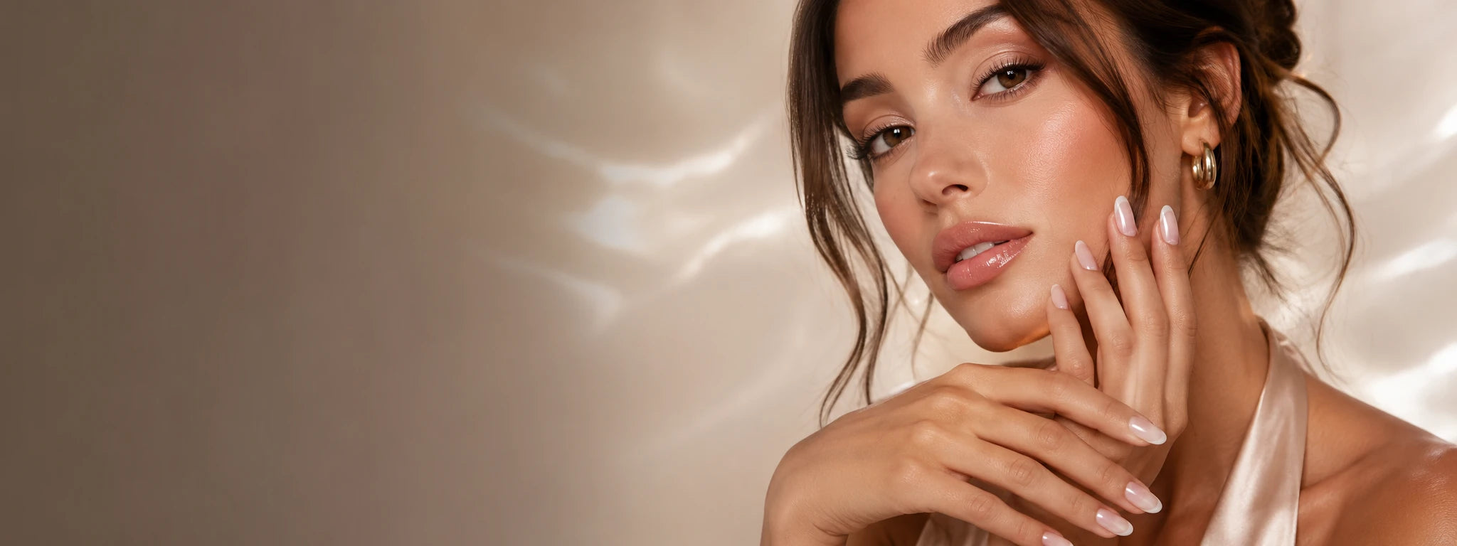 Model wearing glossy neutral Matchy Nails press-on nails in an editorial homepage hero image